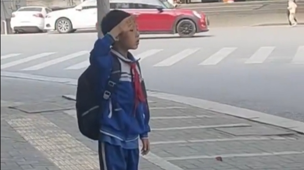 湖南平江小学生感冒上学晚到，听到国歌声停步原地敬礼