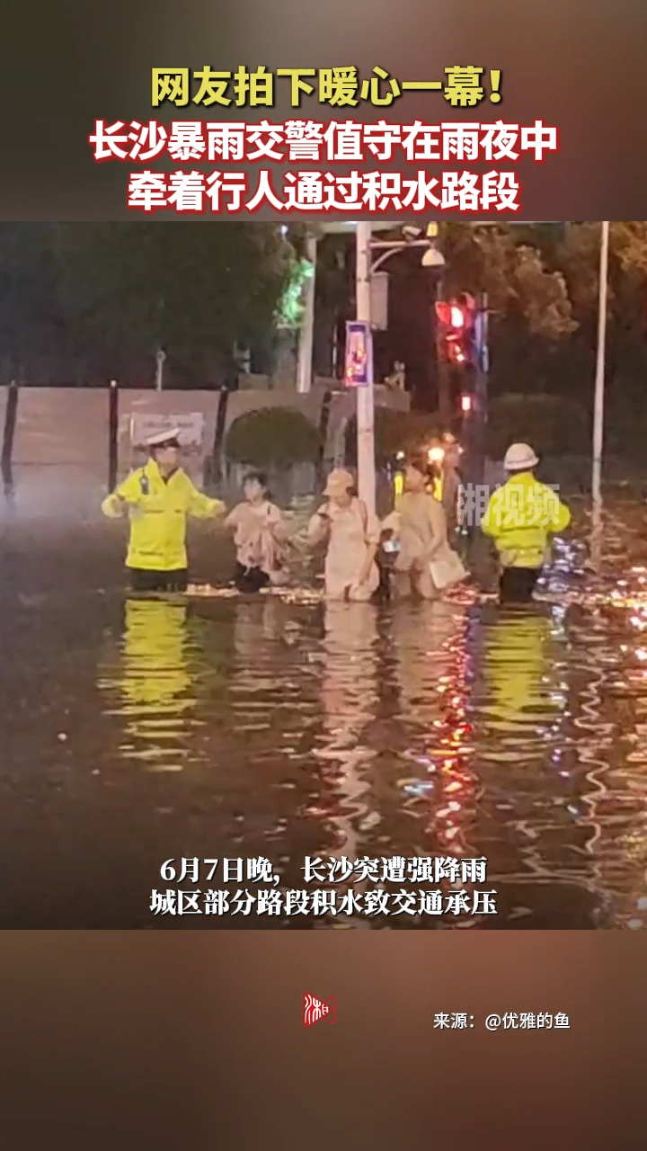 网友拍下暖心一幕！长沙暴雨，交警在雨夜中值守，护送行人通过积水路段