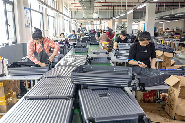 Workers Busy Producing Luggage and Suitcases