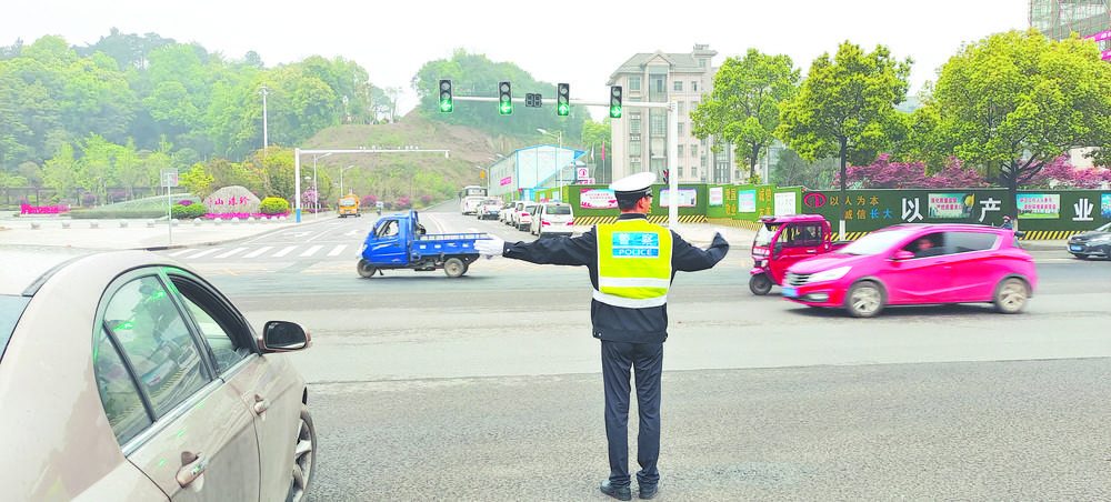 圖為交警正在新開通的路口指揮交通.